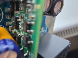 Close-up of a circuit board with visible capacitors and electronic components.