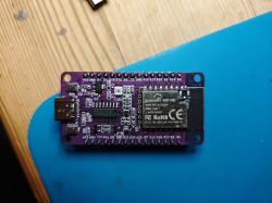 SparkFun BW16E module with Wi-Fi chip on a blue surface