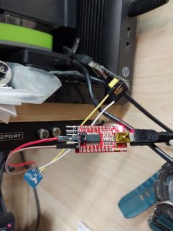 Microcontroller connected to a computer via USB cables and electronic wires.