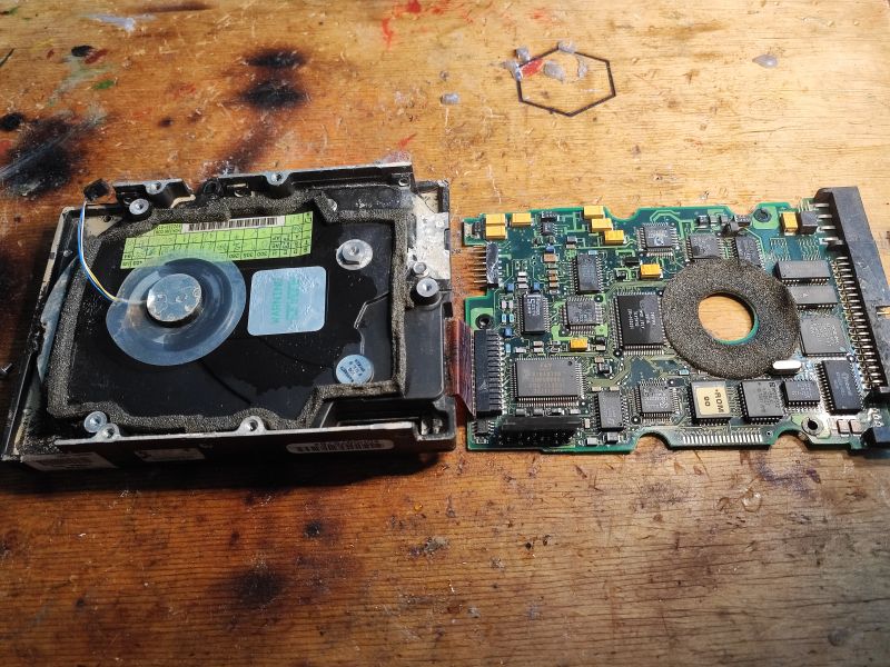 Seagate ST3390A Hard Drive from 1994 Disassembled Seagate ST3390A hard drive from 1994 next to a circuit board.