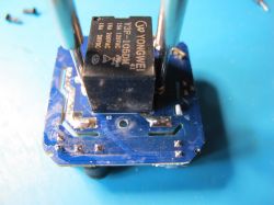 Interior of a Smart Plug with Yongwei Relay Interior of a smart plug with Yongwei relay on a blue PCB.