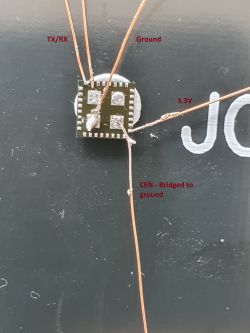 Close-up of T34 chip with soldered wires.