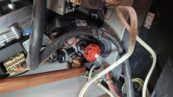 Wnętrze urządzenia elektronicznego z widocznymi przewodami i elementami konstrukcyjnymi.