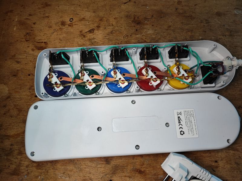 Interior of Power Strip with Colorful Sockets Interior of a power strip with colorful sockets and visible wiring.
