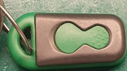 Zbliżenie na przycisk pilota samochodowego w obudowie z tworzywa sztucznego.