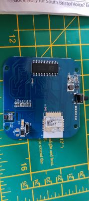 A blue circuit board with various electronic components.