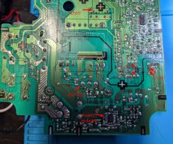 Bottom side of a green PCB with red arrows marking voltage test points and labels