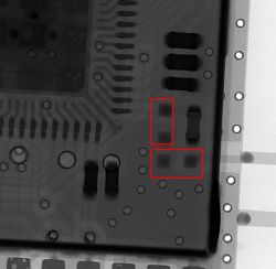 X-ray image of an electronic circuit with highlighted areas of missing components.