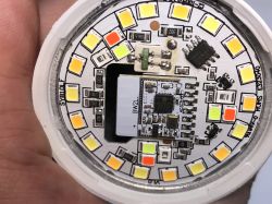 Close-up of the interior of a circular printed circuit board with multiple LEDs and electronic components.
