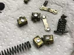 Set of Metal Parts and Springs Metal parts and springs lying on a paper towel.