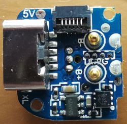 Electronic module on a blue board with connectors and components.