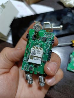 Circuit Board with Electronic Components A person holds a green circuit board with mounted electronic components.