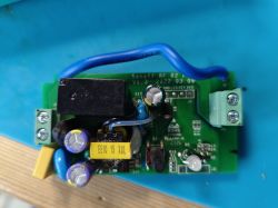 Printed circuit board with electronic components and a blue wire.