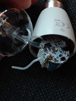 Close-up of a LED lamp interior showing a white wire and circuit board.