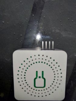 Electronic device with visible pins and a symbol on the casing.