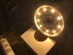 Close-up of a glowing LED light with visible electronic components on the circuit board.