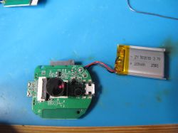 Camera Module with Battery on PCB A circuit board with a mounted camera lens and a connected lithium-polymer battery.