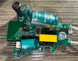 Close-up of an electronic circuit with various components, including capacitors and resistors, on a printed circuit board.