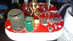 Close-up of electronic components on a red printed circuit board.
