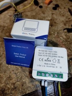 Close-up of the CozyLife LN882H smart switch with visible user manual and packaging.
