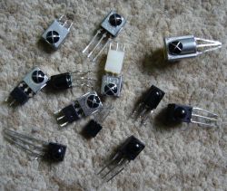 Several IR receivers with different casings and pin counts lying on a carpet.