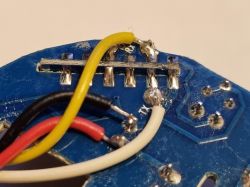 Close-up of a PCB with soldered wires and a metal slide switch.