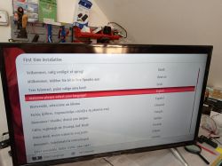 TV screen displaying language selection during initial setup.