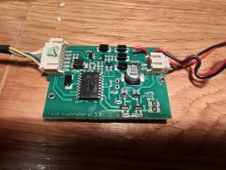 Płytka elektroniczna Lock controller v1.3.2 z przewodami i podzespołami na tle drewnianym