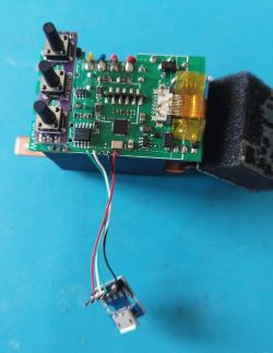 Electronic module with three buttons and a micro USB connector on blue background.