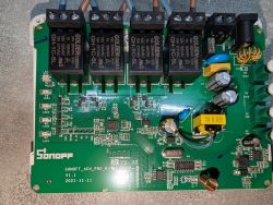 Sonoff 4CH Pro R3 PCB with four relays and electronic components on a green background.
