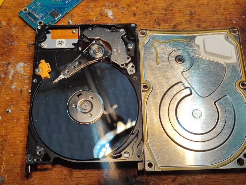 Interior of Water-Damaged Hard Drive Interior of an open hard drive showing details of the platter and the actuator arm with the head.