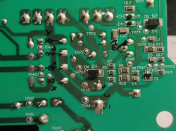 Image of a green printed circuit board with component labels and test points.