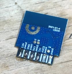 Electronic module with labeled pins on a blue PCB board.
