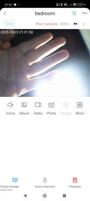 Hand lit by camera light in monitored bedroom Hand illuminated by bright light in front of a surveillance camera in a room
