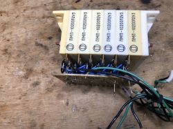 Six white “ПМП-10200П2У3” modules on a PCB with wires, placed on a wooden workbench