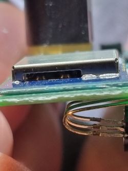 Close-up of an electronic module with pins.