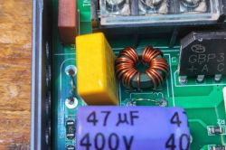 Power supply section with ferrite choke, capacitors, and bridge rectifier visible