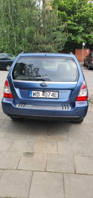 Rear view of a blue Subaru Forester parked outdoors.
