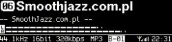 Close-up of an OLED screen showing “Smoothjazz.com.pl” with MP3 320 kbps details and time 22:34