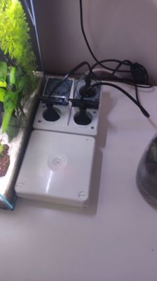 DIY Aquarium Controller with Four Power Sockets Four 230V sockets next to an aquarium with connected cables, next to a white electrical box.