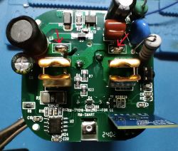 PCB with Marked Damage Close-up of a PCB with components and two arrows pointing to damage.
