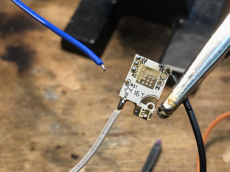 WiFi LN882H Module PCB with UART Wires Connected Close-up of a PCB with connected wires, prepared for programming a WiFi module.