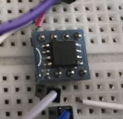 Memory chip on DIP8 adapter placed on a breadboard with connected wires