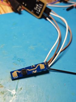 Blue WiGig sensor with chip and wires on a blue work mat