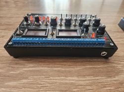 SIMAT-25 Controller for PLC Testing SIMAT-25 controller with knobs and switches on a wooden table.
