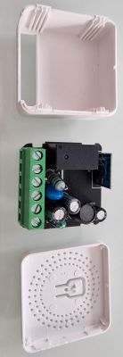 Disassembled Mini Smart Switch 16A WIFI View of a disassembled Mini Smart Switch 16A WIFI, showing internal components and its casing.