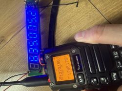 Ręczne radio i moduł licznika częstotliwości z niebieskim wyświetlaczem, oba pokazują ok. 72,5 MHz