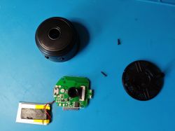 Disassembled A9 Mini Camera Disassembled A9 mini camera with visible PCB and battery.