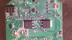 Close-up of a PCB with electronic components and signs of burn damage