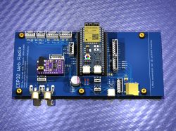 Render of a board with an ESP32 module, chinch sockets, and various electronic components.